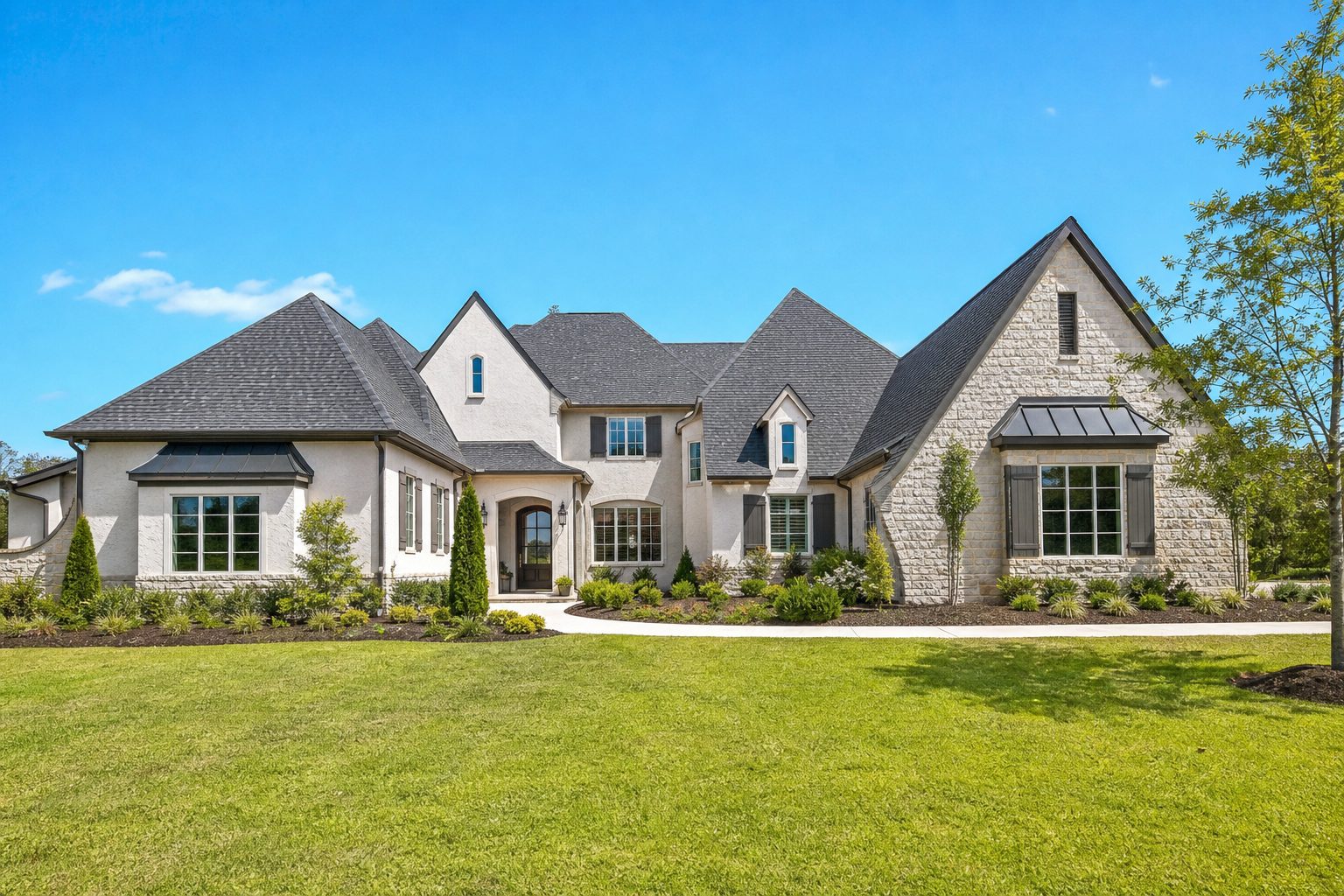 Well-kept residential property with finished landscaping work and clear open sky